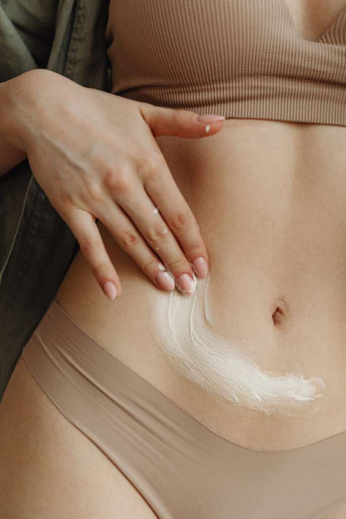 How to reinvent yourself physically by taking care of your skin. Woman applying lotion on her stomach