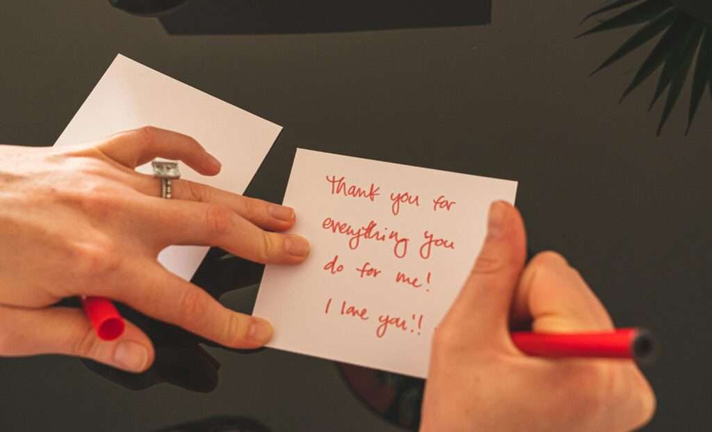 Image of a woman writing a thank you letter.