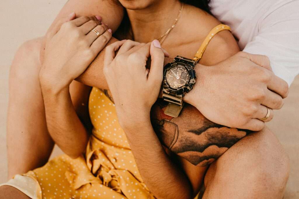 How to reinvent your relationship by learning your significant other love language. A man wrapping his arm around a woman from behind