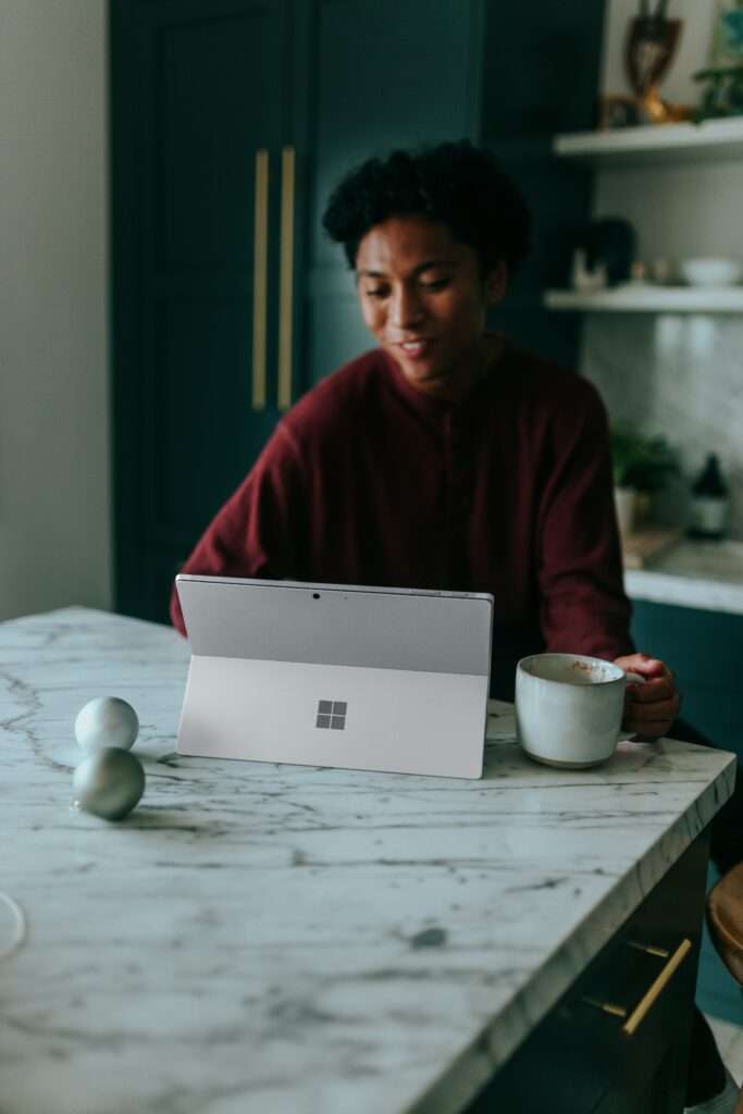 How to reinvent yourself professionally by networking with others in your career field. Image of woman conversing on tablet.