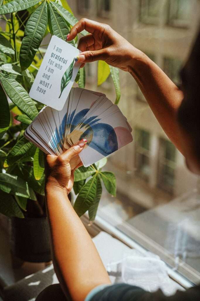 A woman reading affirmation cards.