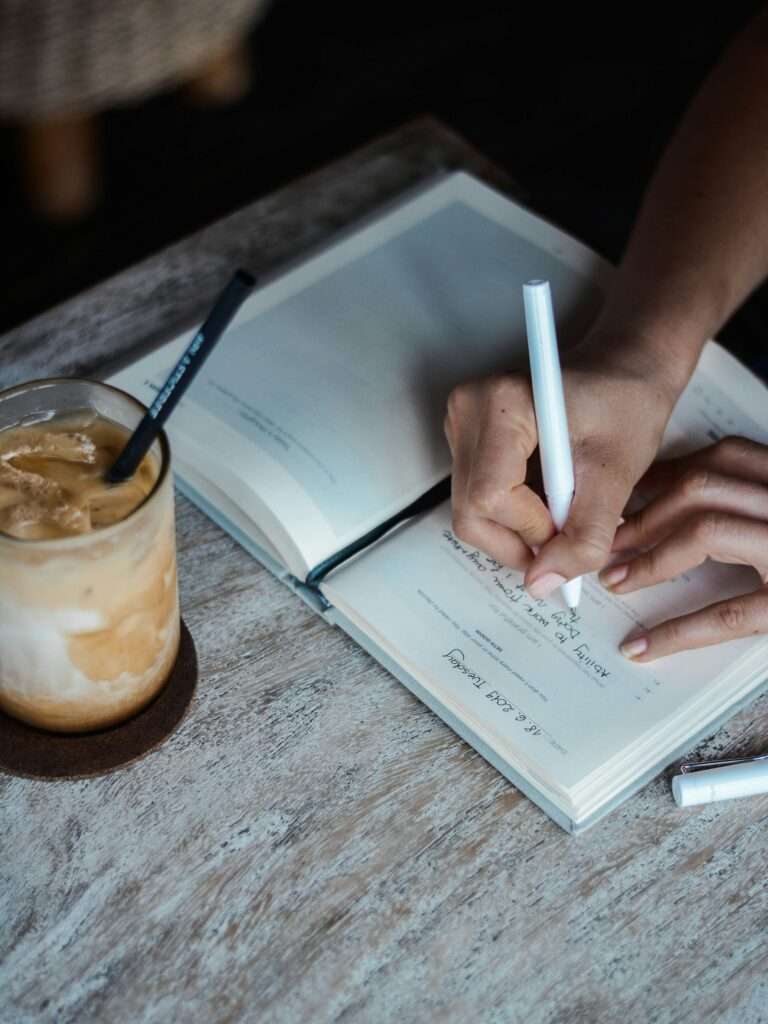 Woman writing down to-do-list.
