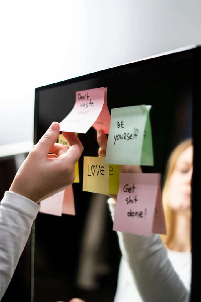 A woman placing affirmations around her house
