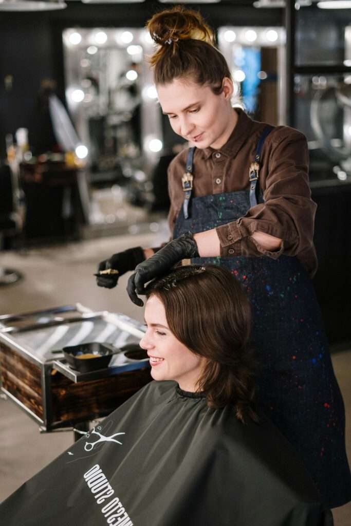 Woman dyeing another woman's hair