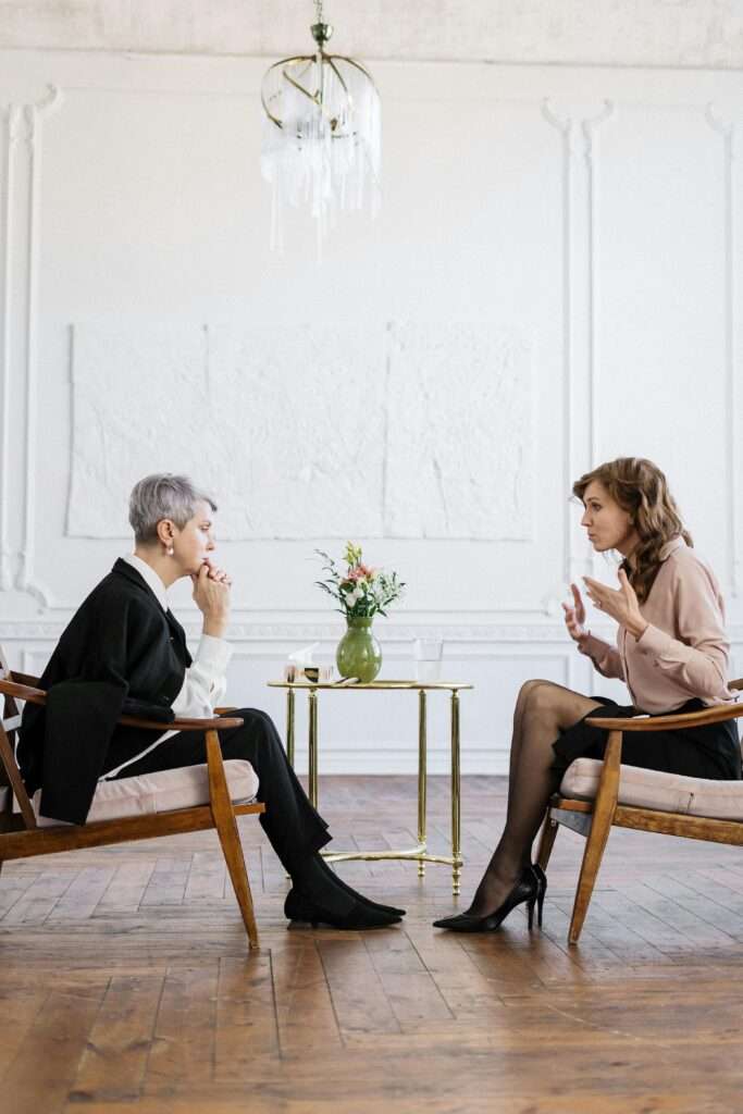 Women sitting face to face while talking