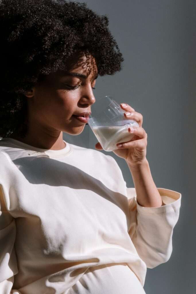 A woman drinking a glass of water