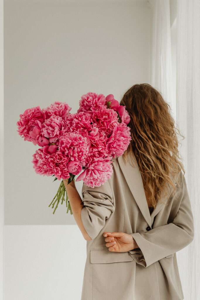 Woman holding pink flowers