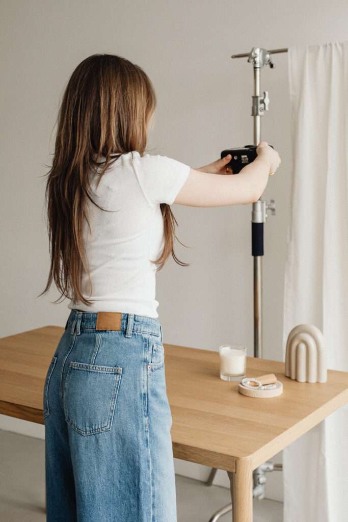 Image of a woman setting up camara