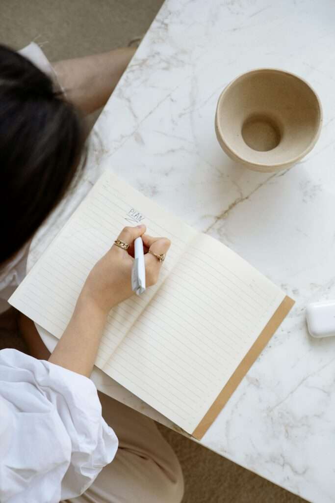 Image of a woman writing in a notebook