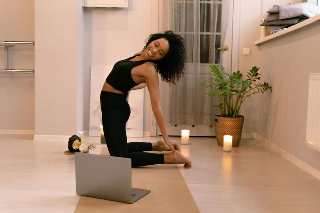 Image of a woman having a candlelit yoga