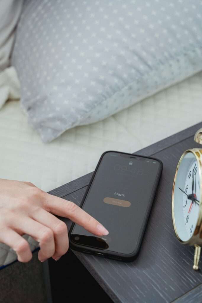 Woman stopping her phone alarm.