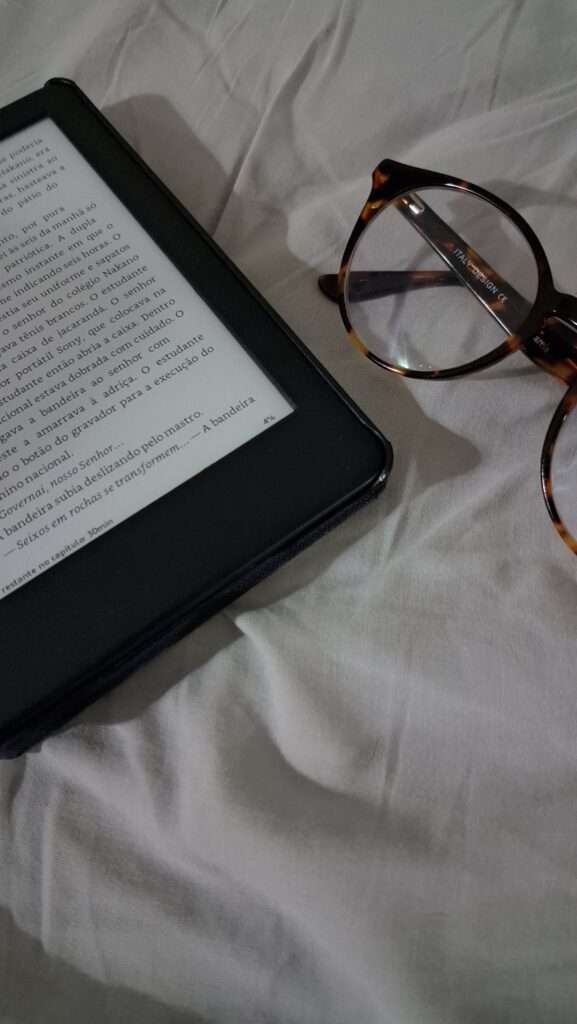 Image of s Kindle and a reading glasses