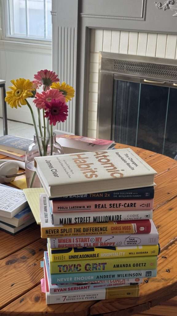 Image of non-fictional books stacked on a coffee table.