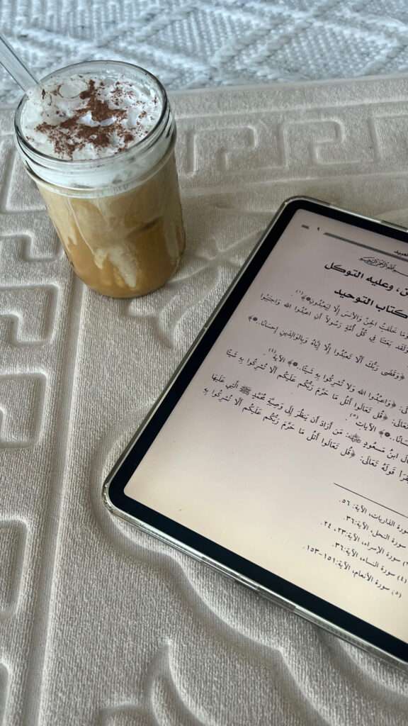 Image of a cold coffee and an ipad on a white mat
