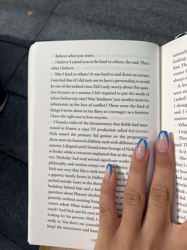 Image of a woman hand on a book.