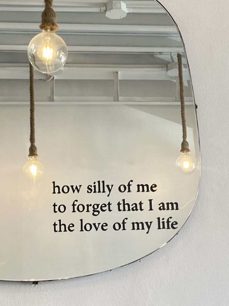 An image of a self-love quote on a mirror.