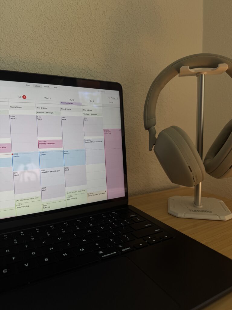 An image of a laptop and headphones on a desk